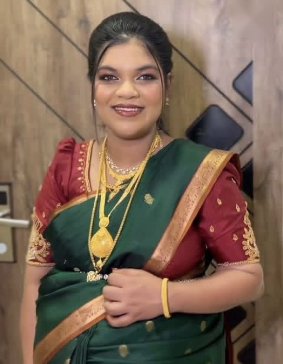 A bride in a green and maroon silk saree with gold jewellery, makeup by Safira